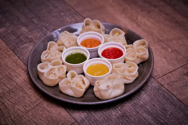 Steamed momo served with four house chutneys