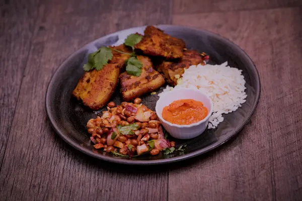 Grilled chicken sekuwa with rice, soybean salad and achar