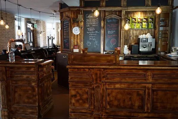 Bar counter with chalkboard coffee menus and espresso machine